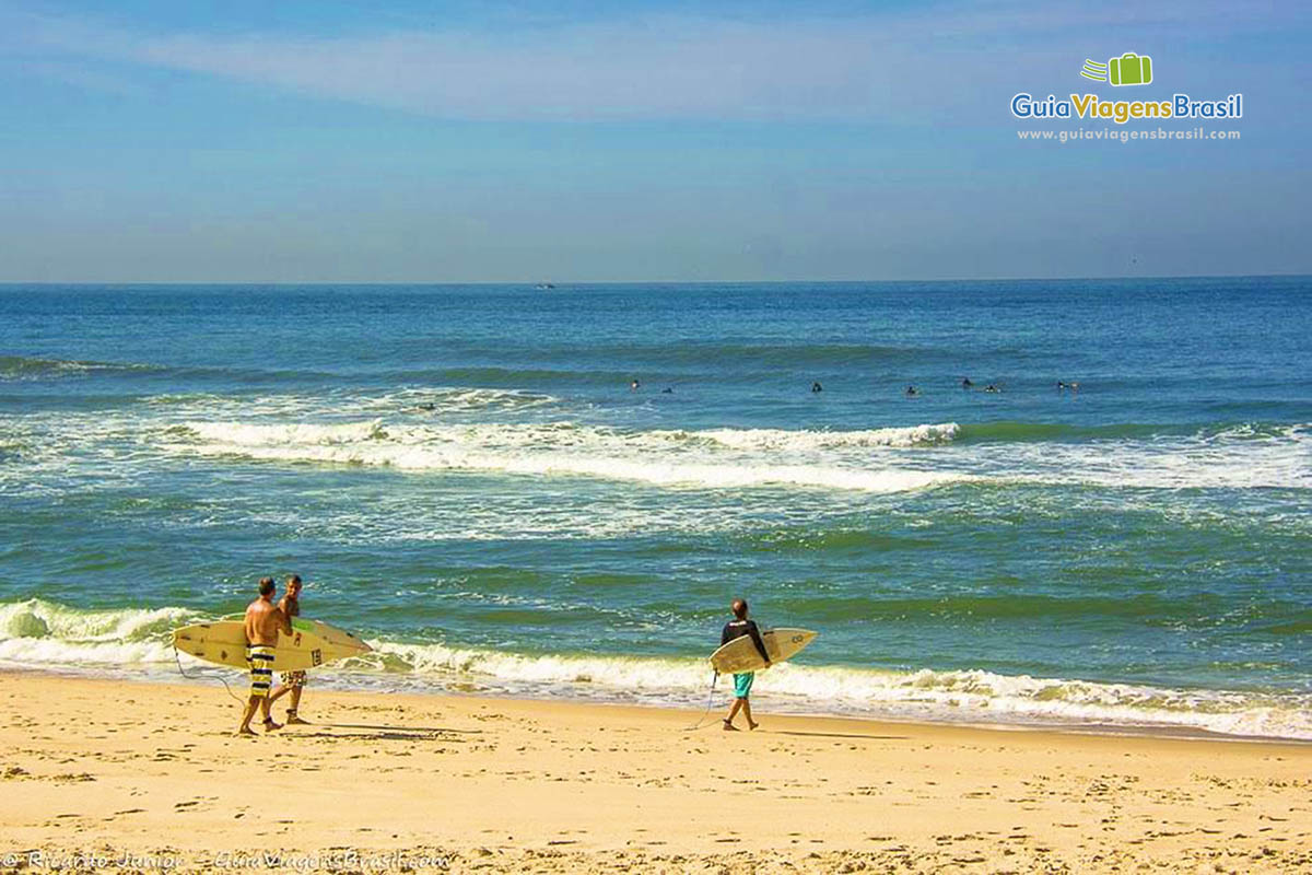 Imagem de amigos surfistas se encontrando nas areias da Prainha.