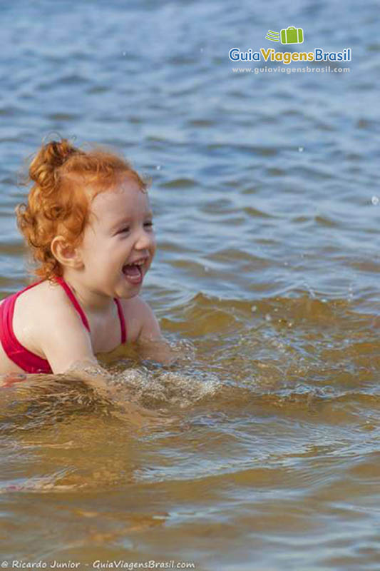 Imagem de uma criança na lagoa.